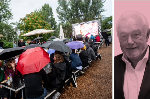 Menschen verfolgen im Regen bei einem Public Viewing die Fußball-Europameisterschaft der Frauen 